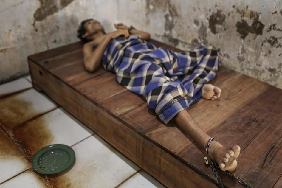 中爪哇省勿里碧县宾那雷斯塔里（Bina Lestari）精神病院一名男性患者被铁链栓在木板床上。铁链很短，患者不能自由活动，只能在小房间里解决吃、睡和排泄。