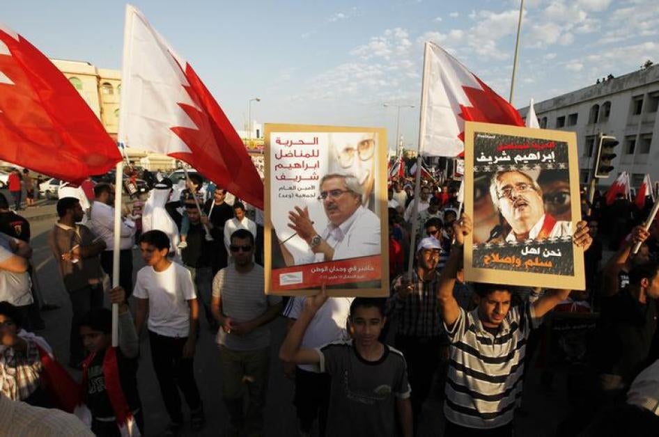 Protesters hold pictures of political prisoner Ebrahim Sharif as they participate in a protest held in the village of Sanabis, west of Manama, Bahrain on December 22, 2012. 