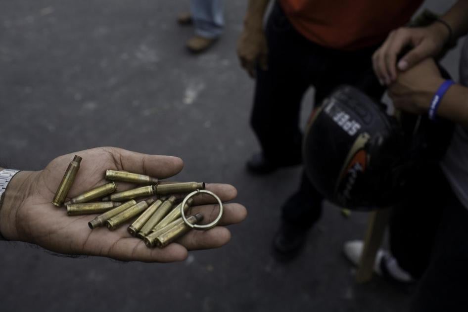 Demonstrators show brass casings, which they collected from those left behind by the soldiers after the shooting. 
