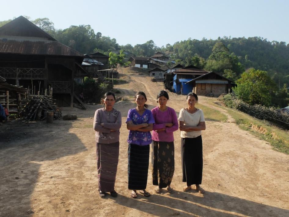 Residents of Ngot Ngar village, Kutkai township, Shan State, in front of their homes, which have come under attack from the Burmese military. 