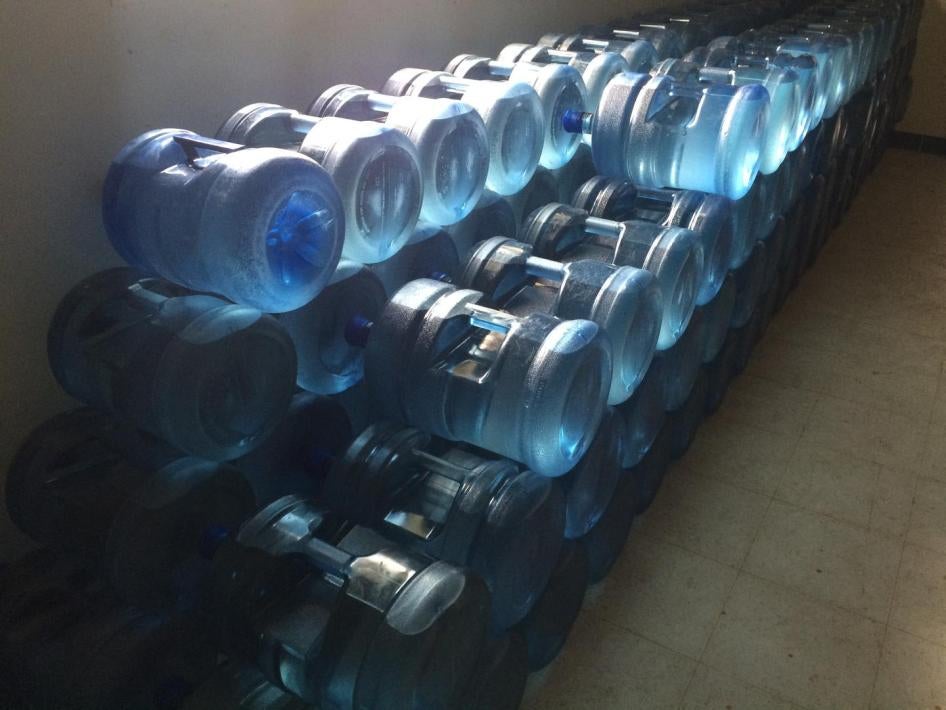 Bottled water stored in Shoal Lake 40 First Nation community building. The First Nation has been on a boil water advisory for close to two decades. Ontario, Canada, August 2015.