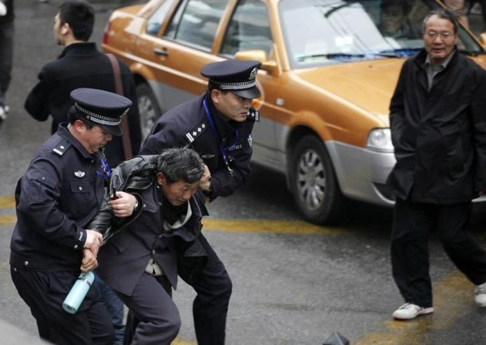 Police arrest a man in downtown Shanghai, after calls for a "Jasmine Revolution" protest on February 27, 2011.