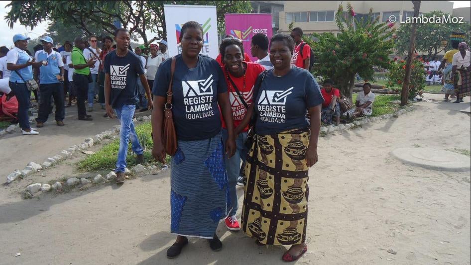 A member of Lambda Mozambique is joined by relatives during an event to raise awareness about HIV/Aids, December 2014.