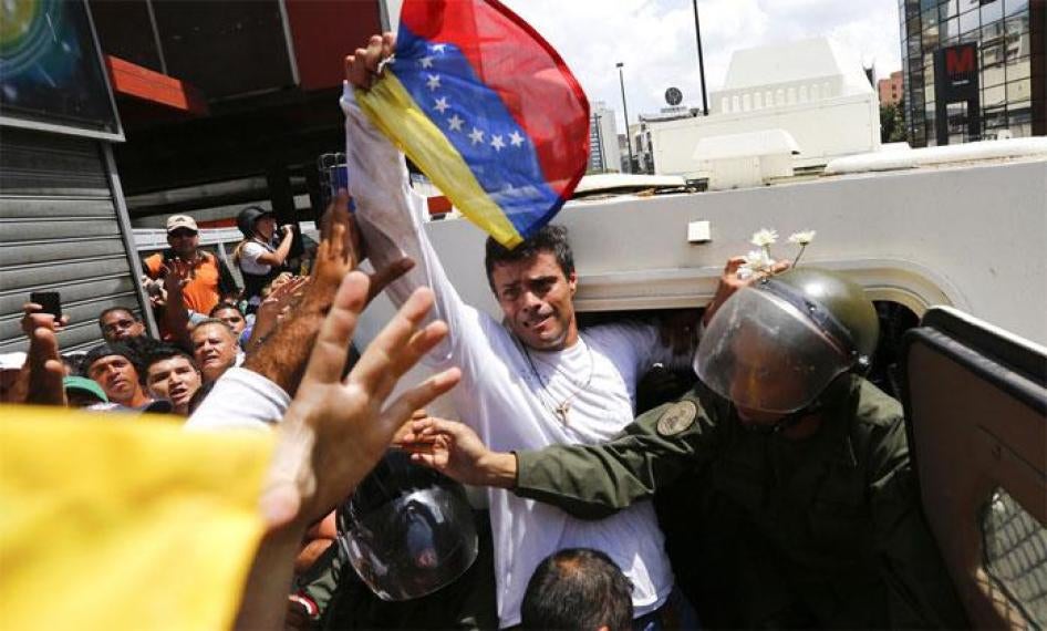 Venezuelan opposition leader Leopoldo Lopez gets into a National Guard armored vehicle