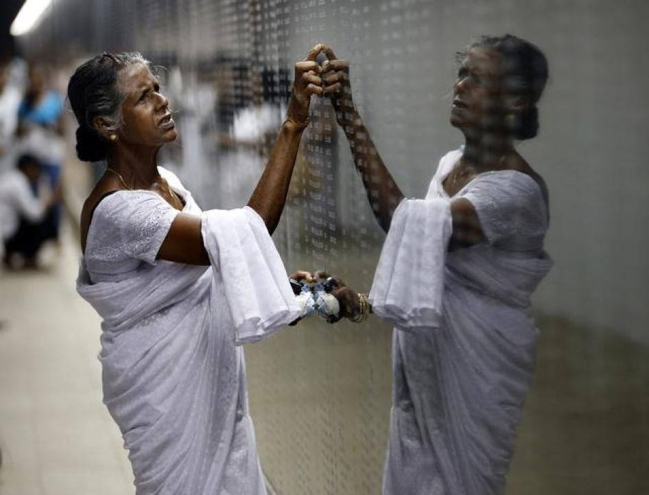 A woman looks for her son's name at the war memorial in Colombo, Sri Lanka on May 19, 2014.