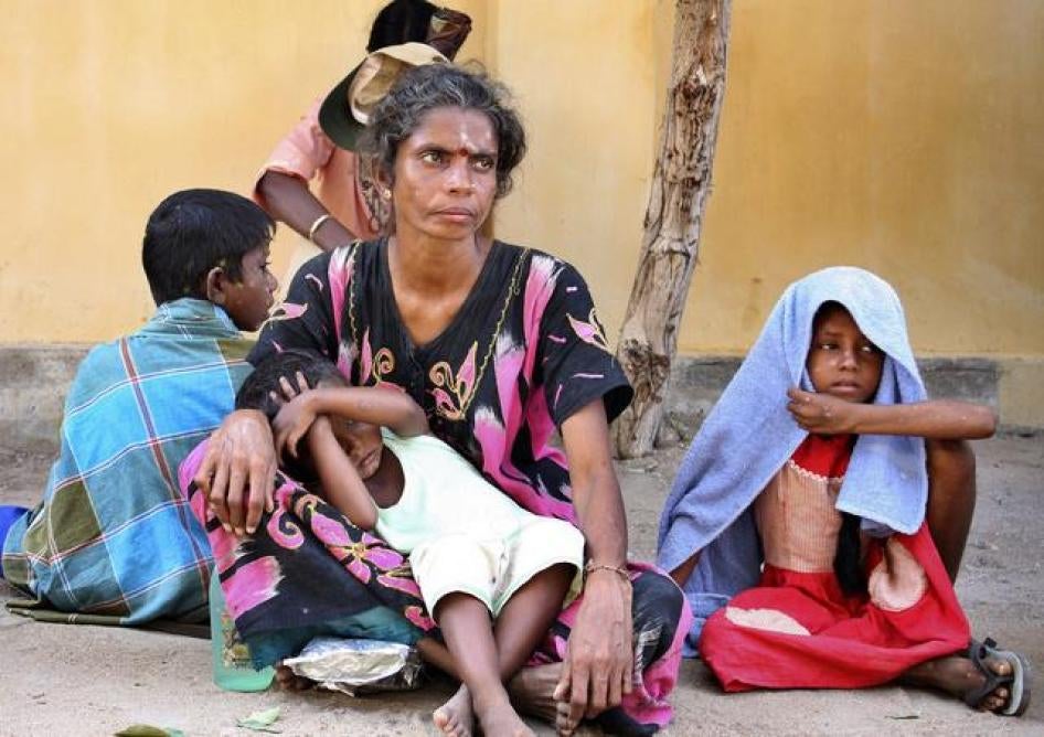 A family of internally displaced Sri Lankan Tamils wait in Kathankulam village in Mannar, Sri Lanka on October 22, 2009.