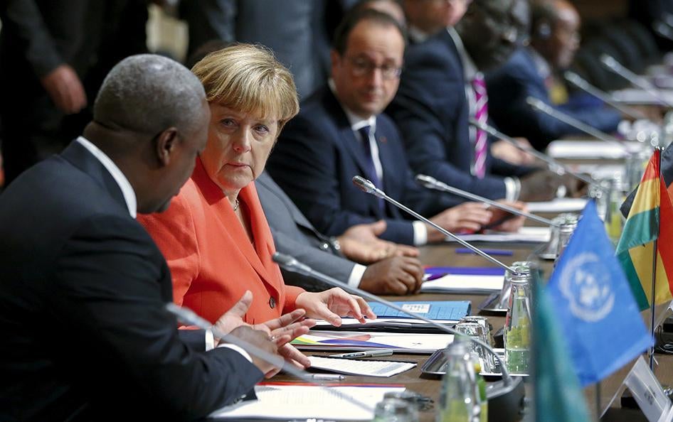 German Chancellor Angela Merkel speaks with Ghana's President John Dramani Mahama during the Valletta Summit on Migration on November 11, 2015.