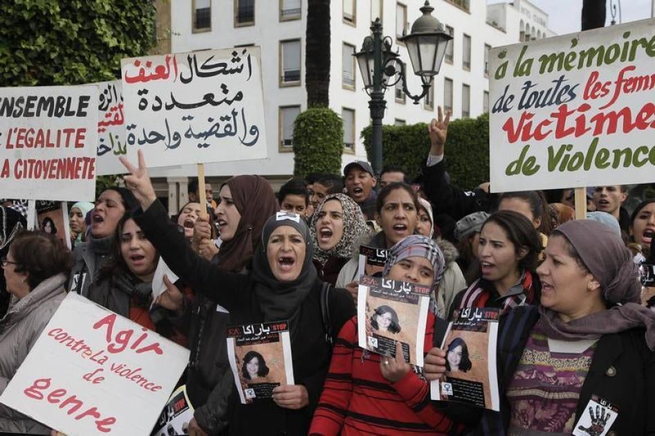 Women from various regions of Morocco hold placards as they protest against violence towards women, in Rabat November 24, 2013. The placard reads, "In memory of all women victims of violence". 