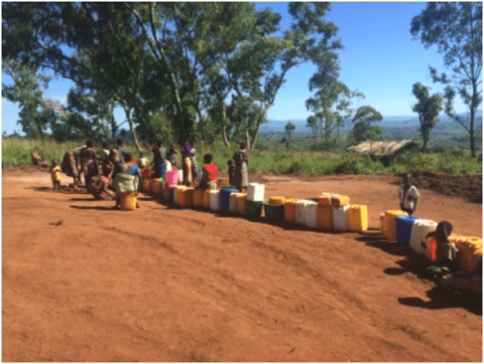 Women and girls at one of the two only borehole wells at the crowded Kapise camp in Malawi that is now serving over 6000 people. 