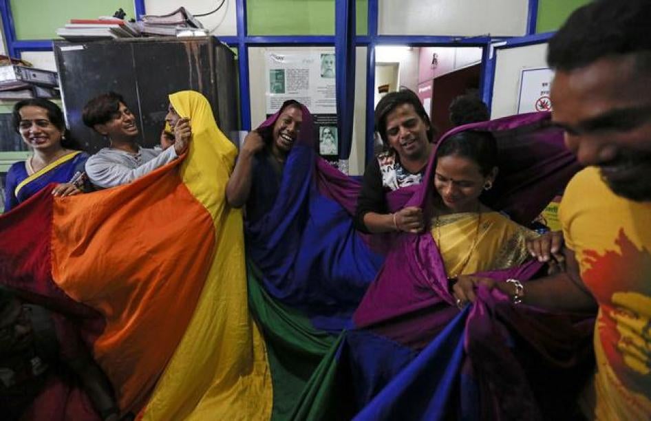 LGBT rights activists in Mumbai cover themselves with a rainbow flag after the Supreme Court announced on February 2, 2016 that it would hear an appeal of its 2013 decision that upheld a discriminatory law criminalizing same-sex relations. © 2016 Reuters