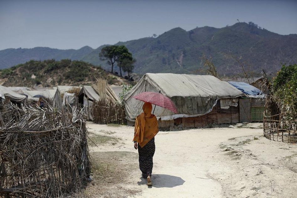 A Rohingya woman walks at an IDP camp in Pauktaw, Arakan State on April 23, 2014.