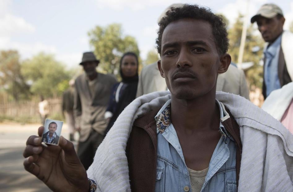 Mersen Chala holds a photo of his brother Dinka, who was killed by Ethiopian security forces a day earlier, in Yubdo village, Oromia region, about 100 kilometers from Addis Ababa, December 2015.