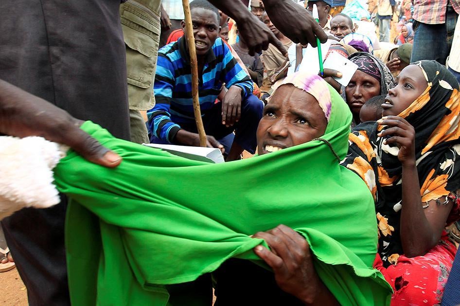 A newly arrived Somali refugee is forced out of the queue outside a reception centre in the Ifo 2 refugee camp in Dadaab, near the Kenya-Somalia border, in Garissa County, Kenya