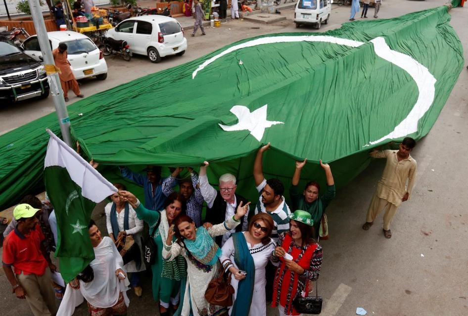 Supporters of civil rights group for transgender people, the Gender Interactive Alliance (GIA), dance and chant slogans as they pose with a national flag ahead of the Independence Day in Karachi, Pakistan August 3, 2016