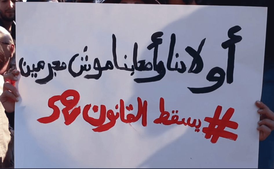 Manifestation en faveur de l’abrogation de la Loi 52 sur la drogue, tenue le 28 décembre 2015 devant le Palais du Bardo à Tunis, où siège le Parlement tunisien. La bannière comporte le message : « Nos enfants et nos amis ne sont pas des criminels ».