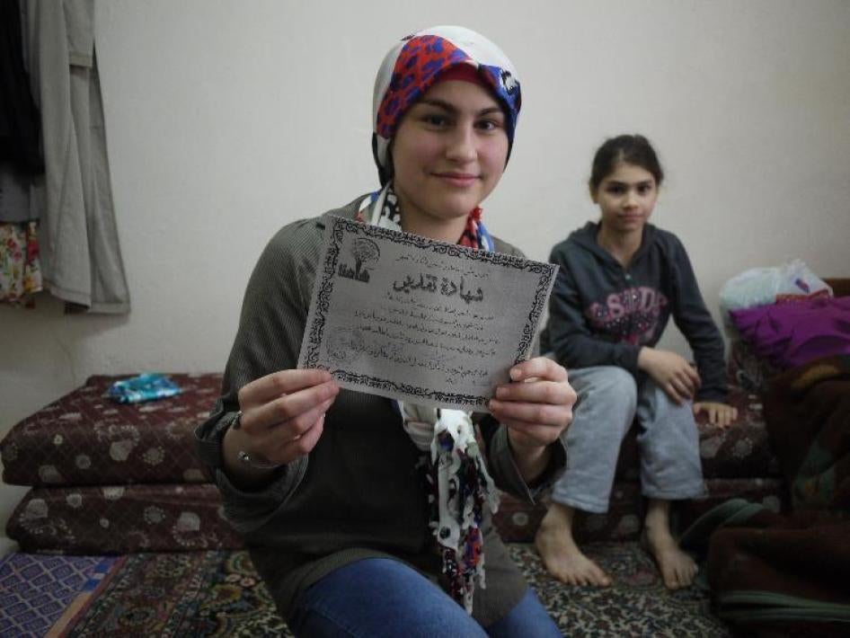 Rawan, 14, holds the certificate she received upon completing the 4th grade at a Syrian temporary education center in Istanbul. She missed nearly four years of school prior to her enrollment in January 2015 [