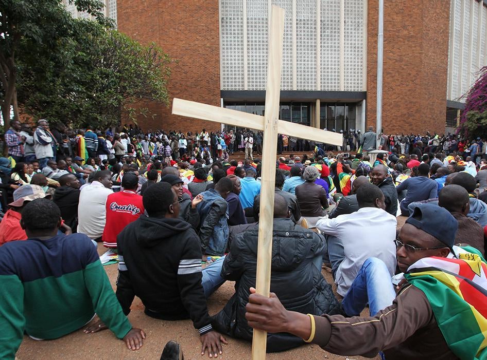 Supporters of Zimbabwean Pastor Evan Mawarire, outside the Harare Magistrates Court during his trial on July 13, 2016.