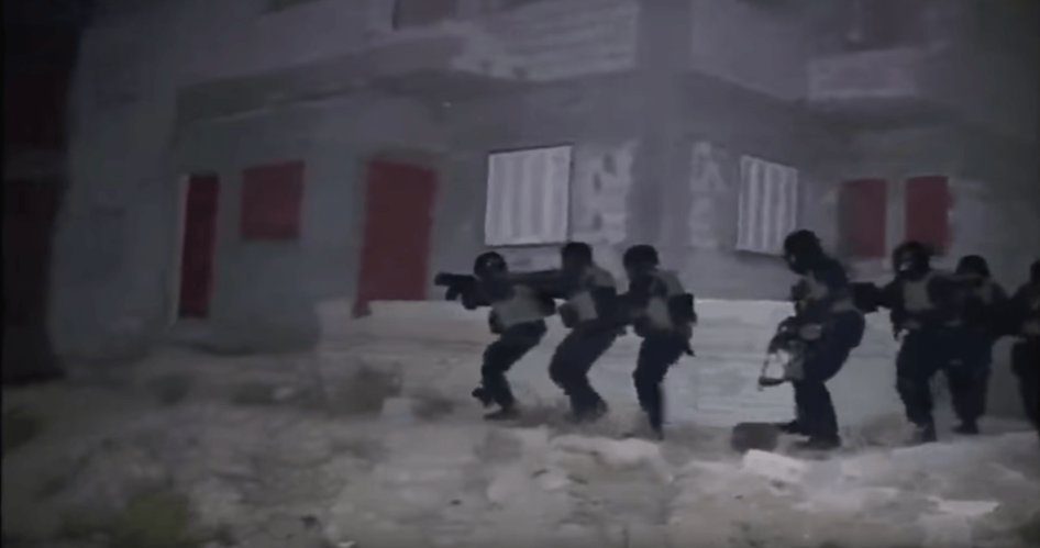 Still from a video published by the Egyptian Interior Ministry. The video shows commandos stealthily approaching a building. But military experts said the bright, white light illuminating the commandos during their approach was one indication that the rai