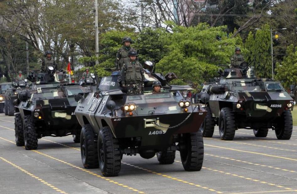 Government troops stand atop of armoured personnel carriers during the celebration of the 77th founding anniversary of the Armed Forces of the Philippines (AFP) inside the Camp Aguinaldo military headquarters in Quezon city, metro Manila December 21, 2012