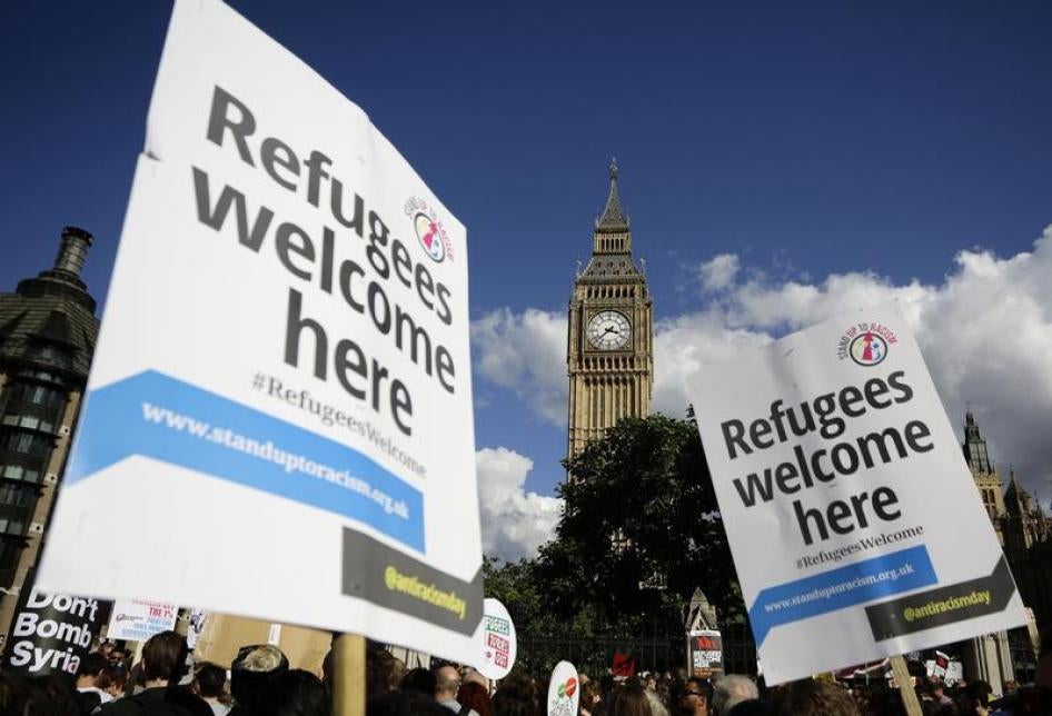 Protesters hold up placards during a demonstration to express solidarity with migrants and to demand the government welcome refugees into Britain, in London, September 12, 2015.