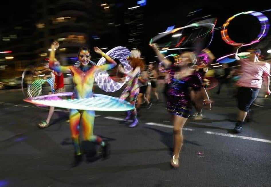 Participants dance with hula hoops during the 2014 Sydney Gay and Lesbian Mardi Gras parade, Australia, March 1, 2014.