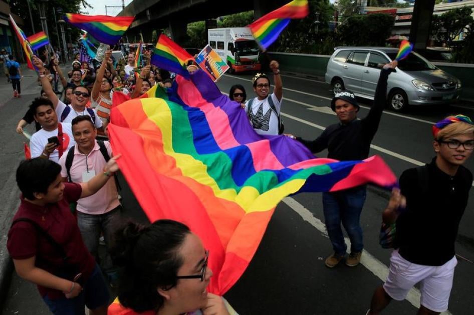 Supporters wave rainbow flags while marching during a LGBT Pride parade in metro Manila, Philippines June 25, 2016.
