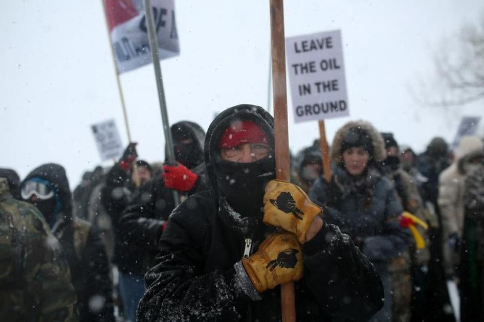 A Native American man leads a protest march with veterans and activists outside the Oceti Sakowin camp at the Standing Rock Indian Reservation, near Cannon Ball, North Dakota, U.S., December 5, 2016.