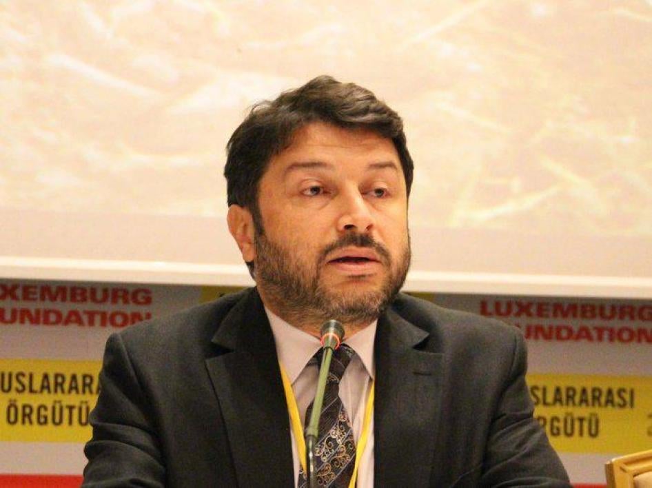 Taner Kilic, head of Amnesty International Turkey, speaks at a conference.