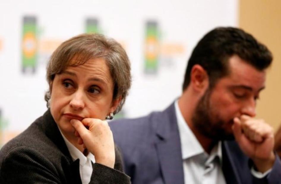 Mexican journalist Carmen Aristegui listens beside Mario Patron, Director of Human Rights Center Miguel Agustin Pro Juarez (PRODH) during a news conference in Mexico City, Mexico June 19, 2017