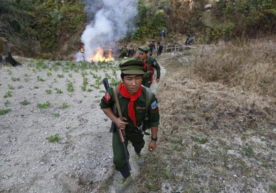 Ta’ang National Liberation Army soldiers burn an opium field in northern Shan State, January 16, 2014.