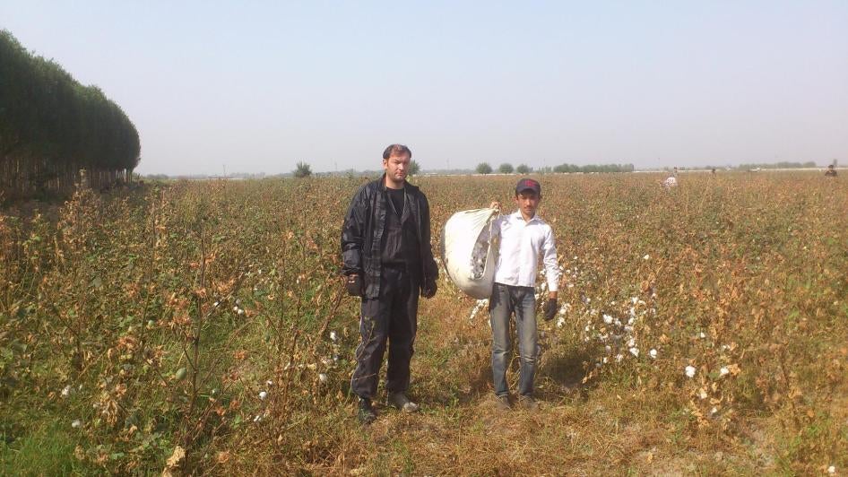 Dmitry Tikhonov (on the left), a journalist and human rights defender, stands with a cotton worker, September 2013. 