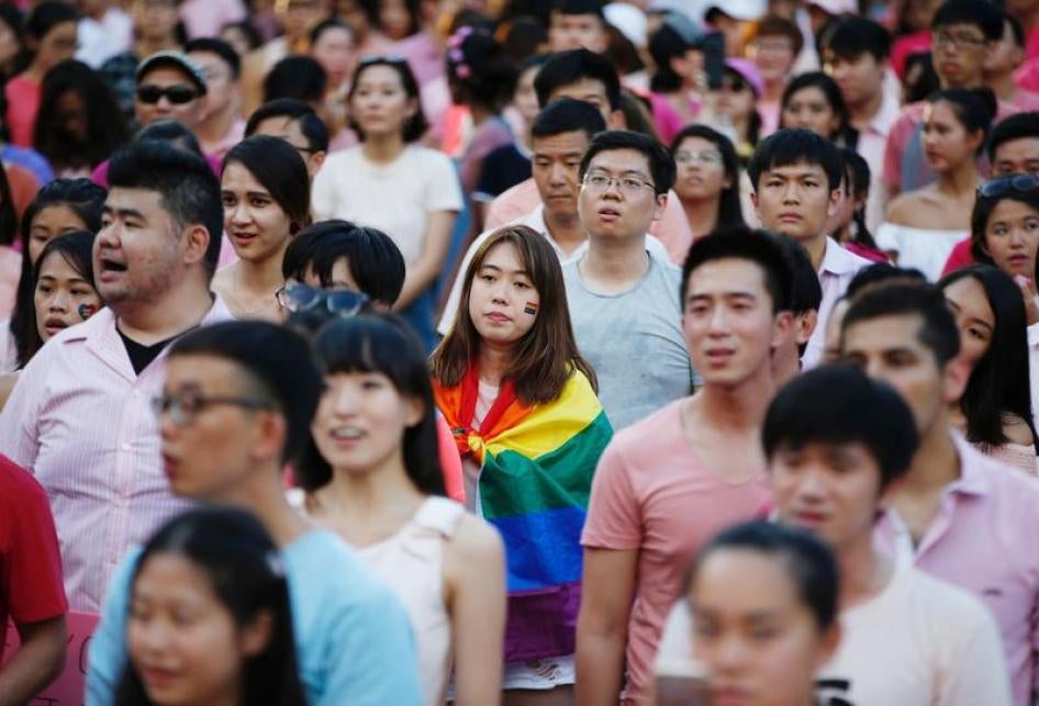 A woman wrapped in the rainbow flag is seen at the Pink Dot rally, Singapore's annual gay pride rally, at a park in Singapore July 1, 2017. 