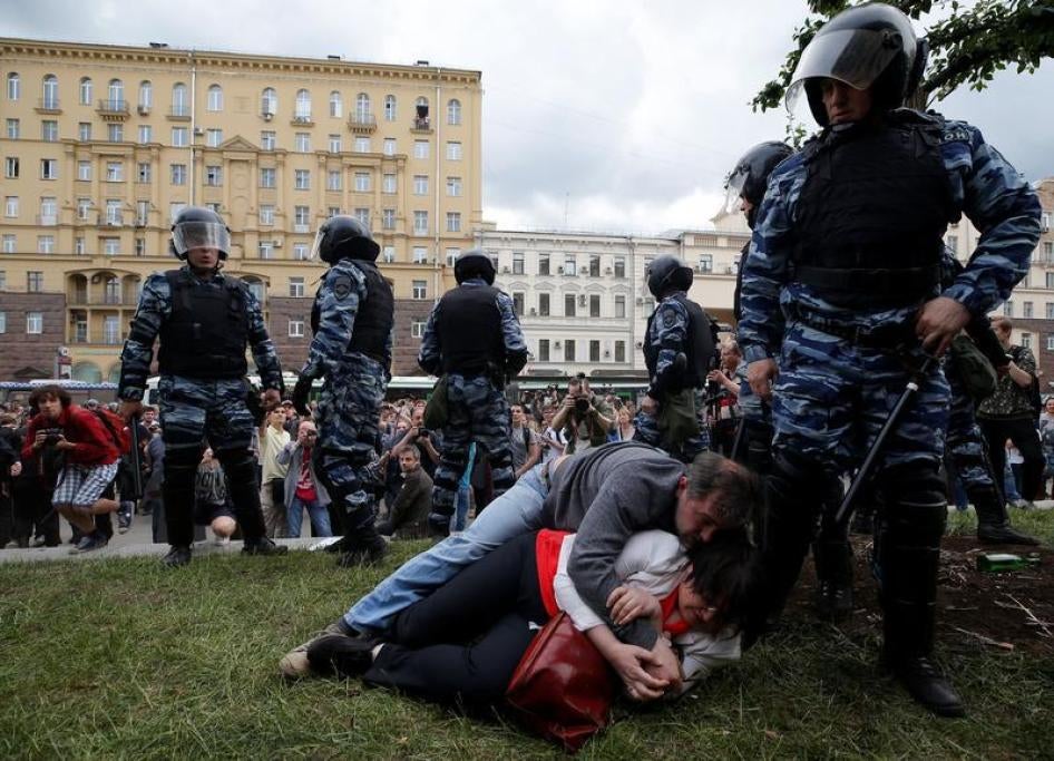 Activist Yulia Galyamina and her husband Nikolai Tuzhilin lie on the ground next to riot police during an anti-corruption protest on Tverskaya Street in central Moscow, Russia, June 12, 2017. 