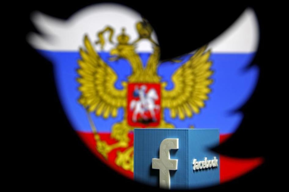 A photo illustration interweaving the Russian flag with the Facebook and Twitter logos taken in Zenica, Bosnia and Herzegovina, May 22, 2015. Russia's media watchdog has warned that Google, Twitter and Facebook could be blocked if they do not comply with 