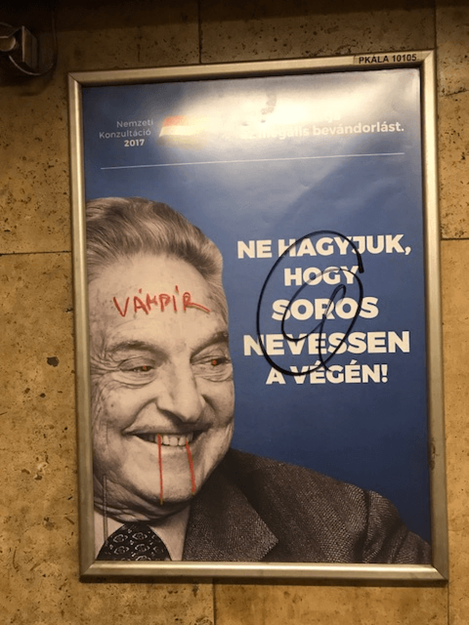 Anti-Soros campaign poster defaced with "vampire" scribbled across Soros' face. Budapest metro, July 12, 2017. 