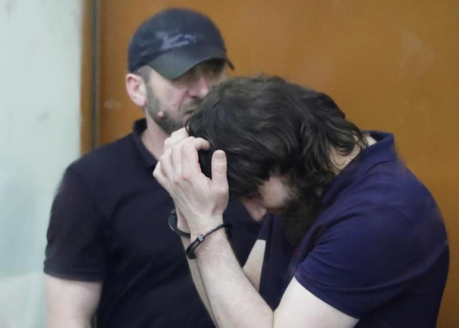 Zaur Dadayev (R) and Khamzat Bakhayev, convicted of involvement in the killing of Russian opposition leader Boris Nemtsov, stand inside the defendants' cage during their sentencing hearing at the Moscow military district court, Russia, July 13, 2017.