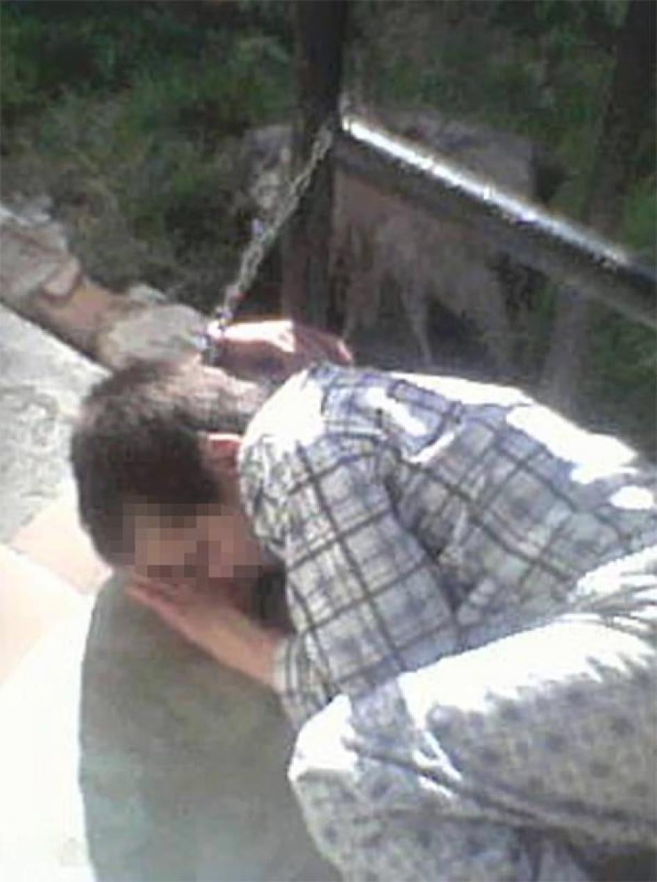 Screenshot of a resident in the Trubchevsk psycho-neurological institution in the Briansk region chained to a metal frame.