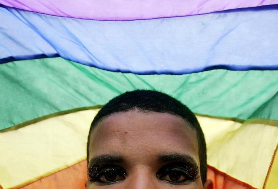 A man shows his rainbow flag during the Gay Pride parade in Rio de Janeiro, Brazil, July 30, 2006.