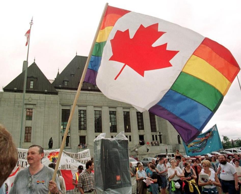 LGBT-rights supporter waves an amalgamation of the Canadian and rainbow flags in front of the Supreme Court of Canada in Ottawa, 1999. In 2017, Canadian government condemned Ramzen Kadyrov’s purge of gay men in Chechnya and announced that nearly 30 victim
