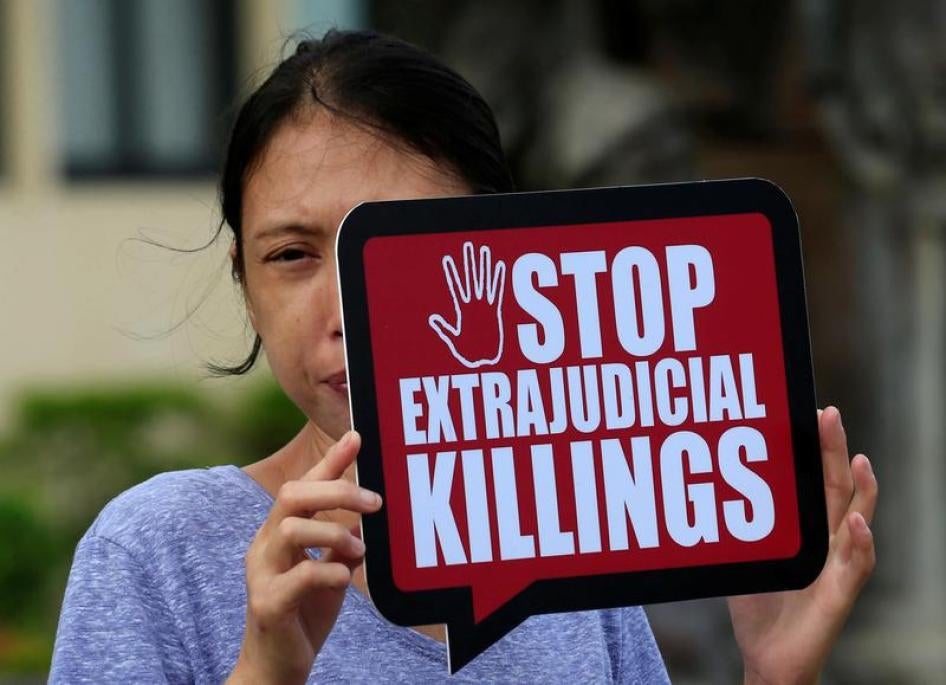 A woman displays a placard during a protest against Philippine President Rodrigo Duterte’s “war on drugs” in front of a local court in Muntinlupa city, south of Manila, Philippines October 13, 2017.