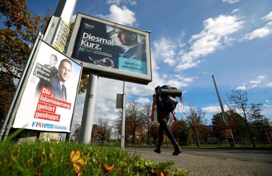 A woman walks past election campaign poster of far right Freedom Party (FPOe) head and top candidate Heinz-Christian Strache and People's Party (OeVP) top candidate and Foreign Minister Sebastian Kurz in Vienna, Austria October 4, 2017.