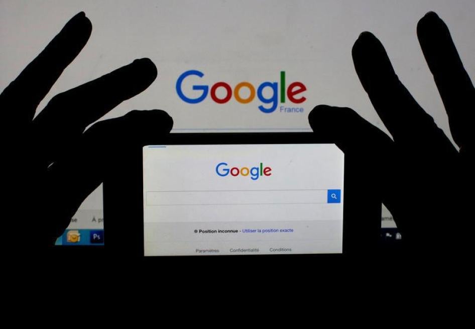 A woman holds her smart phone which displays the Google home page, in this picture illustration taken February 24, 2016.