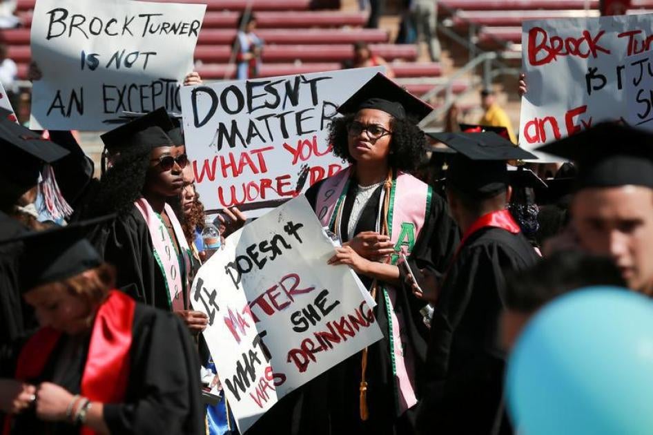 Protesters hold signs to raise awareness of sexual assault on campus at the Stanford University commencement ceremony in Palo Alto, California on U.S. June 12, 2016. 