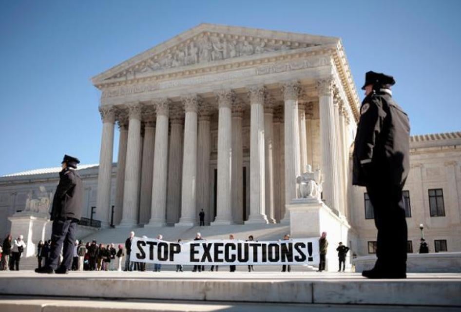 Protesters calling for an end to the death penalty unfurl a banner before police arrest them outside the U.S. Supreme Court in Washington January 17, 2007.