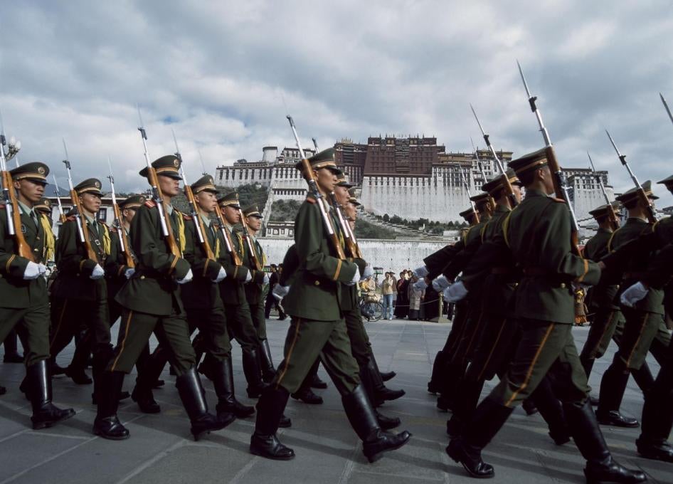 Paramilitary policemen march in formation in front of the Potala Palace during a parade around the March 10 anniversary of the failed 1959 uprising against Chinese rule, March 10, 2017.