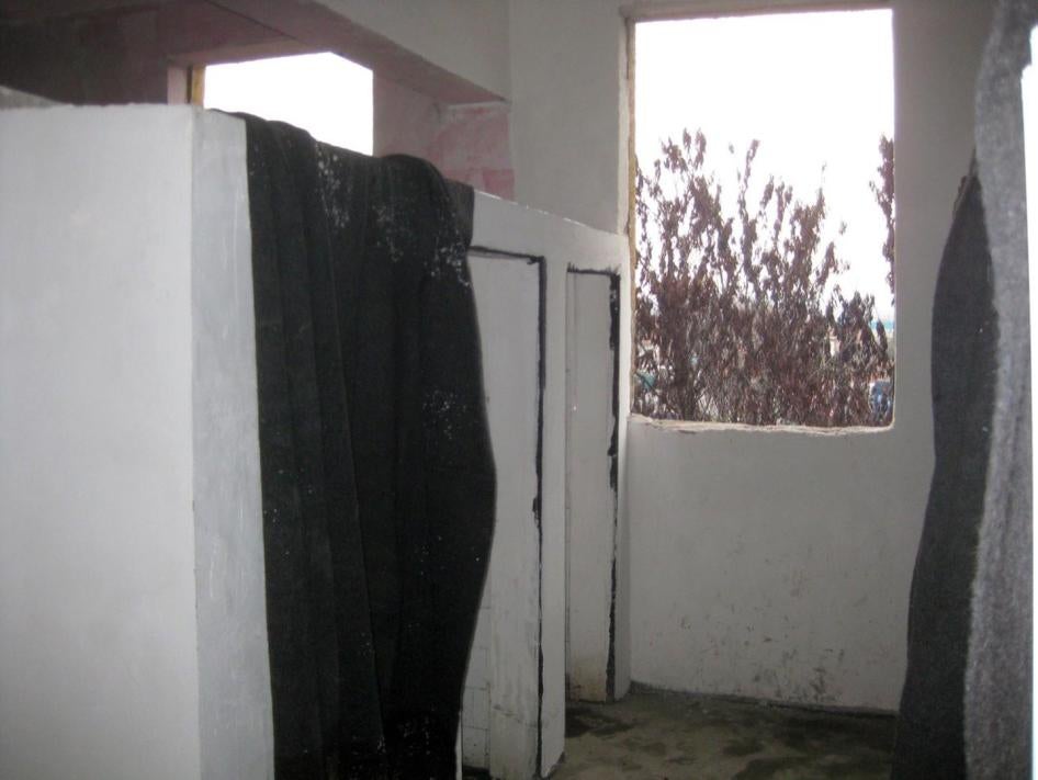 A bathroom in one of the residential buildings in the Harmanli migration center, Bulgaria. The toilets had no doors and the windows had no glass. Temperatures were below freezing. 