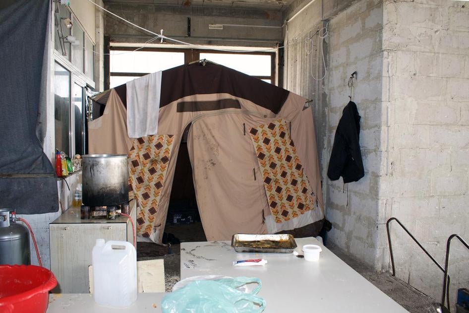 A refugee tent at a squat in an abandoned factory on Lesbos, Greece, where dozens of asylum seekers are living. Due to the dire and dangerous conditions in official facilities, many chose to live in abandoned buildings around Mytilene. 