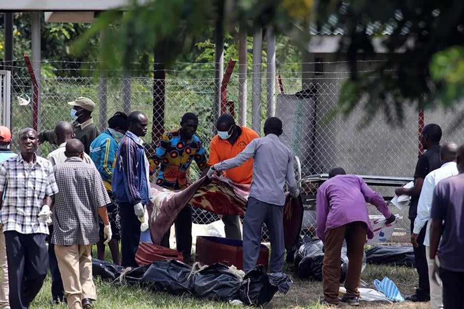 Relatives collect bodies of loved ones who were killed when Uganda security forces stormed the palace of Charles Wesley Mumbere, king of the Rwenzururu, in Kasese town, western Uganda on November 27. 