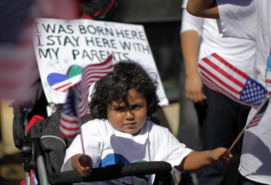 Simon Rodríguez, de 2 años, flamea dos banderas estadounidenses durante una marcha de protesta para exigir una reforma inmigratoria en Los Ángeles, California, el 5 de octubre de 2013. 