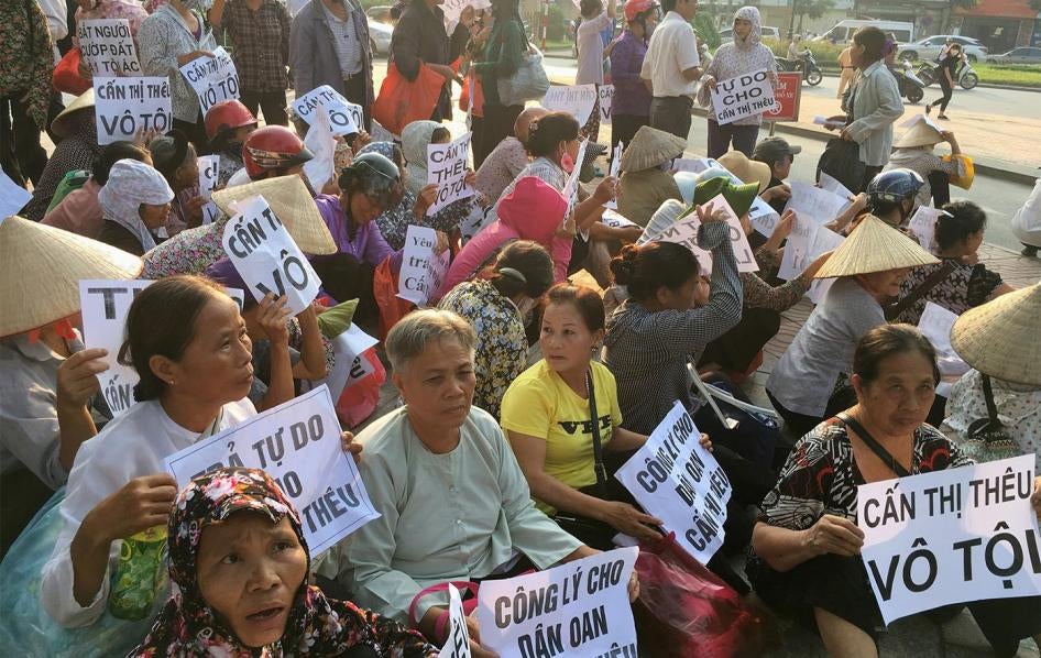 Farmers from Duong Noi village protest during the trial of Can Thi Theu, a farmer and land rights activist in Hanoi. The placards read "Can Thi Theu is innocent," "Justice for innocent Can Thi Theu" and "Make arrest - grabbing land is criminal," September